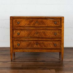 an old wooden dresser sitting on top of a hard wood floor