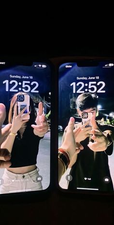 two people taking pictures with their cell phones in front of the same image as they are holding