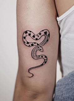 a woman's arm with a snake tattoo on it