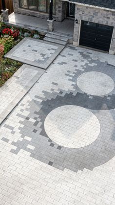 an aerial view of a driveway with circular designs on it