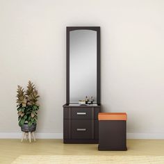 a bathroom with a mirror, stool and plant on the floor in front of it