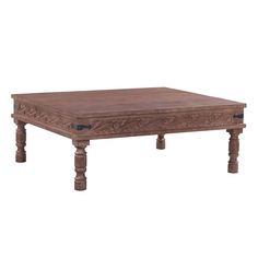 an old wooden table with carvings on the top and legs, against a white background