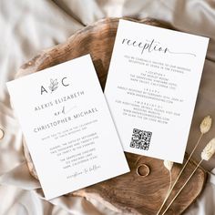 two wedding programs sitting on top of a wooden plate next to dried flowers and leaves