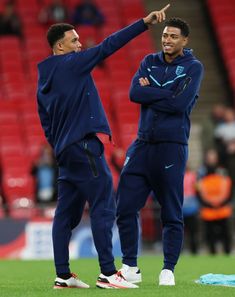 two men standing on top of a soccer field