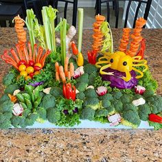 an arrangement of vegetables and crab on a table