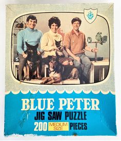 the blue peter jig saw puzzle has two men and a dog on it