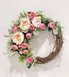 a wreath with pink and white flowers on it