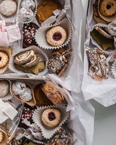 two boxes filled with different types of pastries