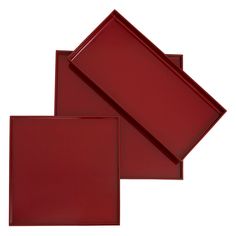 three red glass plates sitting on top of each other