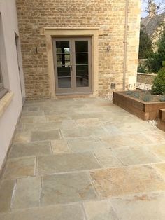 an outdoor patio with stone steps and planters