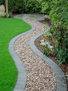 a garden path made out of stones and gravel