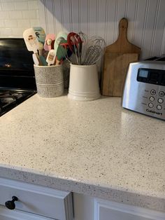 a kitchen counter top with utensils on it