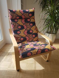 a chair that is sitting in front of a potted plant