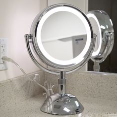 a bathroom mirror sitting on top of a counter