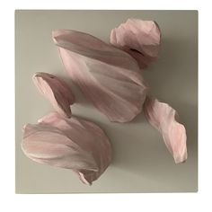 three pink flowers on a gray background