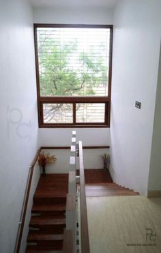 an empty room with wooden steps leading up to the window