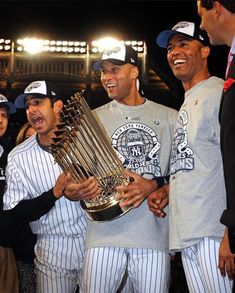 the baseball players are holding their trophies together