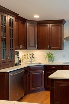 a kitchen with wooden cabinets and white counter tops