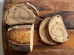 several loaves of bread sitting on top of a wooden cutting board