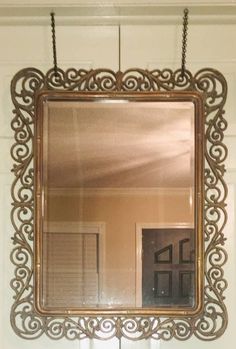 a mirror hanging on the wall above a sink