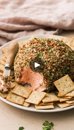 a plate with crackers, cheese and salmon on it