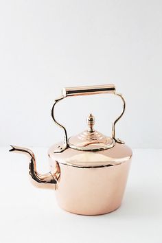 a pink tea pot with a metal handle