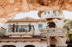 people are standing on the balcony of a house