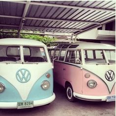 two vw buses are parked next to each other