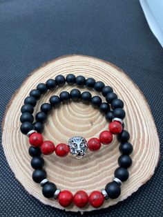 "Introducing \"Judah\" a beautiful matte black, colored bead, and lion centerpiece stretch bracelet. This bracelet can be worn casually or when stepping out more formally. Perfect for both men and women and can easily be added to any bracelet stacks. A great gift for anyone or a to treat yourself. * Black and faux marble/red howlite or wood, pink, Onyx Bracelet *All Judah bracelets are 8 inches long but can be customized by contacting the seller to change length and/or feature bead color." Lion Bracelet, Bracelet Stacks, Red Bracelets, Men Jewelry, Faux Marble, Super Bikes, Handmade Bracelet, Bracelet Stack