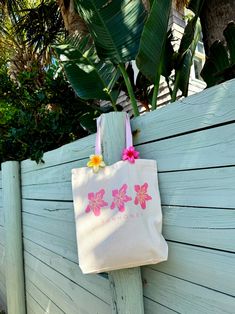 Our Sunhoney Hibiscus Tote Bag is the perfect summer time essential. Say hello to your new favorite beach, grocery, weekend tote bag! This tote features our classic hibiscus flower with Sunhoney underneath with classic canvas material, pink straps, gusset bottom and hold all the essentials and more! 100% Cotton All accessories are final sale. Summer Pink Cotton Beach Bag, Pink Summer Cotton Beach Bag, Pink Cotton Summer Beach Bag, Pink Cotton Beach Bag For Vacation, Pink Cotton Canvas Beach Bag, Pink Cotton Canvas Bag For Summer, Pink Canvas Beach Bag For Summer, Summer Pink Canvas Beach Bag, Pink Cotton Canvas Bag For Vacation