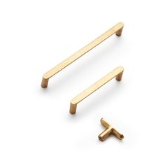 two brass cabinet handles with one handle on the left and one on the right, against a white background