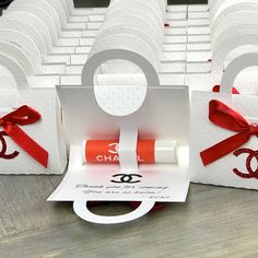 some white boxes with red ribbon and an eye on them