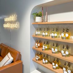 a room filled with lots of bottles of different types of perfumes on wooden shelves