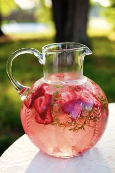 a pitcher filled with liquid sitting on top of a table