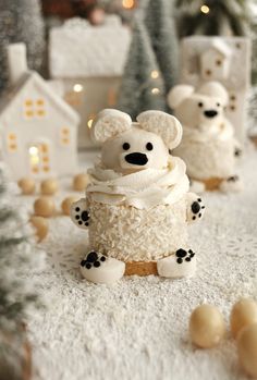 a cake made to look like a teddy bear sitting on top of snow covered ground