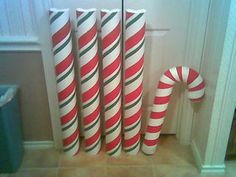 three candy canes sitting next to each other in front of a door