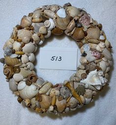 a wreath made out of seashells with a price tag