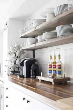 the shelves in this kitchen are filled with dishes