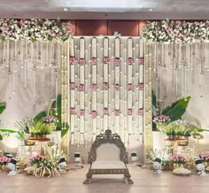 a wedding stage decorated with flowers and greenery