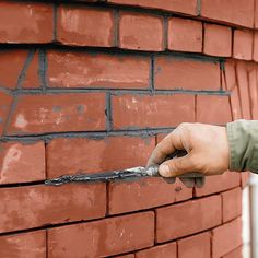 a brick wall being worked on with a naildriver