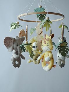 several stuffed animals are hanging from a mobile