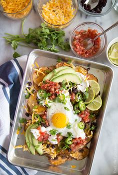 the meal is ready to be eaten on the table, including eggs and other toppings