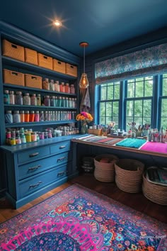 a blue room with lots of crafting supplies and baskets on the floor next to a large window