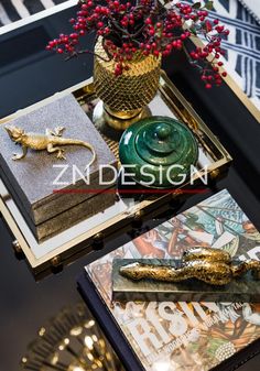 a table topped with books and vase filled with flowers