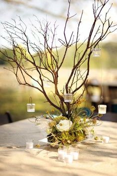 an image of a tree that is in the middle of a table with candles on it