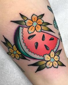 a watermelon tattoo with flowers on it