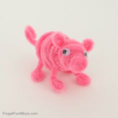 a pink stuffed animal that looks like a dog with big eyes on it's face