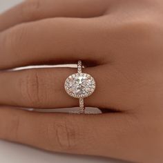 a woman's hand with a diamond ring on top of her finger and an engagement band