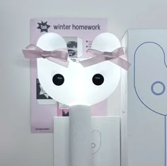 a white mouse lamp with a pink bow on it