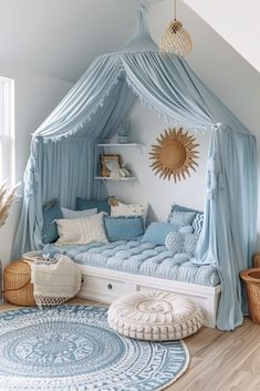 a bedroom with a canopy bed, rugs and pillows on the floor in front of it